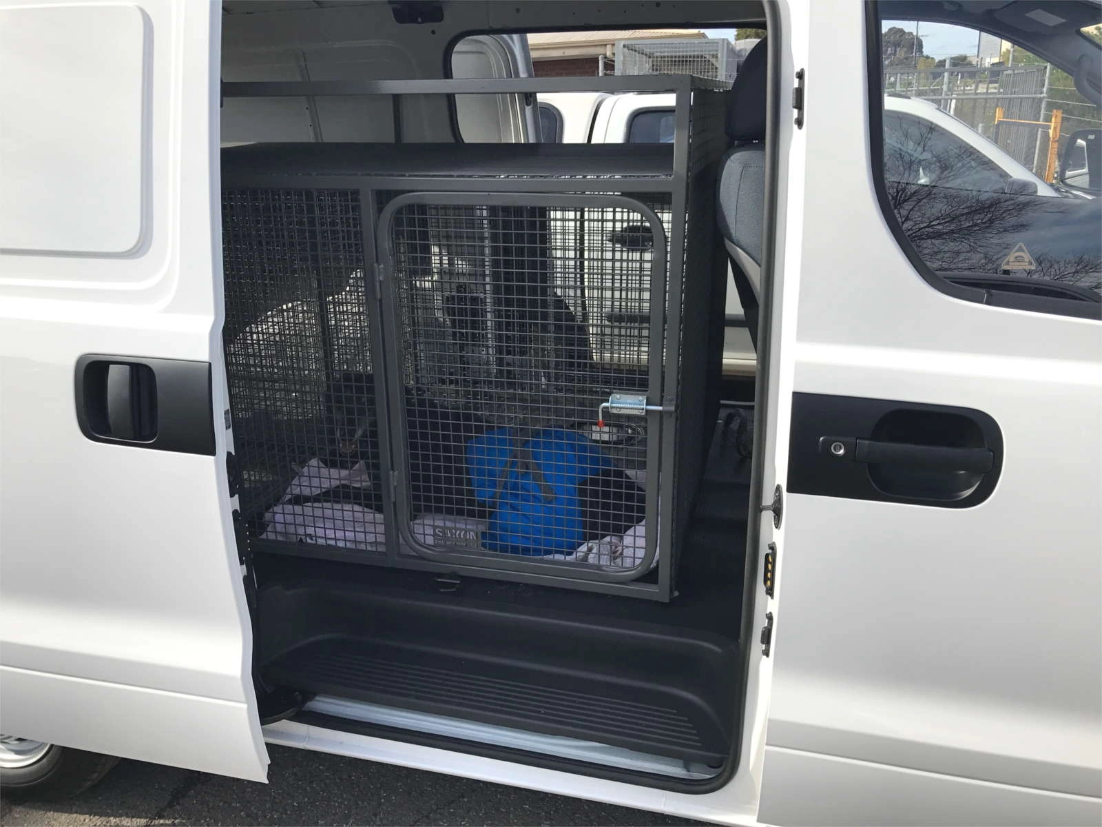 example of Saxon dog transportation cages in use - dog inside cage inside white van